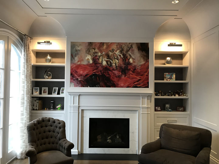 Hand embellished giclee on canvas glued on the wall above the fireplace in a family room